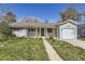 Single story home with attached one-car garage and walkway leading to the front door at 3353 S Glencoe St, Denver, CO 80222