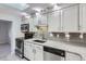 Well-lit kitchen featuring stainless appliances, granite counters, and stylish gray backsplash at 3353 S Glencoe St, Denver, CO 80222