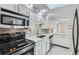 Modern kitchen with stainless steel appliances, granite countertops, and ample cabinet space at 3353 S Glencoe St, Denver, CO 80222