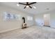 Bright living room with wood stove, plush carpet, and white wood plank ceiling at 3353 S Glencoe St, Denver, CO 80222