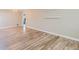 Bright room with hardwood flooring and white trim features blank walls for staging at 3353 S Glencoe St, Denver, CO 80222