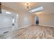 Open living space with skylight, modern lighting, and easy access to laundry and outdoor balcony at 3353 S Glencoe St, Denver, CO 80222