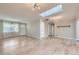 Spacious living room with skylight, hardwood floors, and multiple entryways to other rooms at 3353 S Glencoe St, Denver, CO 80222
