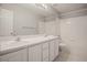 Clean bathroom with double sinks, a large mirror, and a white tiled shower-tub combination at 5755 S Zante Cir, Aurora, CO 80015