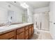 Bathroom features double sink vanity, granite countertops, and glass enclosed shower at 199 Quebec St # M, Denver, CO 80220