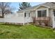 Well-maintained backyard featuring a white fence and green grass, offering a private outdoor space at 12879 E Dickensen Pl, Aurora, CO 80014