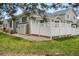 Green backyard with a white fence, well kept grass and exterior building showing awning over windows at 12879 E Dickensen Pl, Aurora, CO 80014