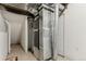Unfinished basement shows furnace and duct work near white door and includes vinyl flooring at 12879 E Dickensen Pl, Aurora, CO 80014