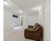 Partially furnished basement featuring a window, carpet, and a comfortable leather sofa at 12879 E Dickensen Pl, Aurora, CO 80014