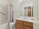 Well-lit bathroom with a shower-tub combo, updated vanity, and tiled floors at 12879 E Dickensen Pl, Aurora, CO 80014
