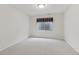 Simple bedroom featuring a window and carpeted floor at 12879 E Dickensen Pl, Aurora, CO 80014