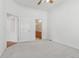 This bright, airy bedroom features a ceiling fan and access to a bathroom and closet at 12879 E Dickensen Pl, Aurora, CO 80014