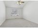 This bedroom offers neutral carpet, a ceiling fan, and natural light from a window at 12879 E Dickensen Pl, Aurora, CO 80014