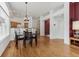 Hardwood floors, recessed lighting, and an open floor plan enhance this living and dining space at 12879 E Dickensen Pl, Aurora, CO 80014