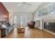 Bright living room featuring hardwood floors, vaulted ceilings, and a charming fireplace at 12879 E Dickensen Pl, Aurora, CO 80014