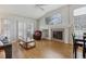 Spacious living room features a fireplace, large windows, hardwood floors, and vaulted ceilings at 12879 E Dickensen Pl, Aurora, CO 80014