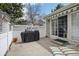 Private patio with a white fence, covered awning, and a grill, perfect for outdoor relaxation at 12879 E Dickensen Pl, Aurora, CO 80014