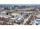 A high-angle aerial view of a community with the stadium in the background on a winter day at 2729 W 28Th Ave # 401, Denver, CO 80211