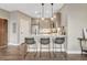 A modern kitchen features stainless steel appliances, pendant lighting, and an eat-in bar with seating at 2729 W 28Th Ave # 401, Denver, CO 80211