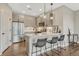 A modern kitchen offers stainless steel appliances, stone countertops, and seating at the eat-in bar at 2729 W 28Th Ave # 401, Denver, CO 80211
