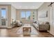 A light and airy living room offers modern furnishings and balcony access for in-town living at 2729 W 28Th Ave # 401, Denver, CO 80211