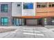 An apartment building has secure parking with a garage door and glass entry with brick accents at 2729 W 28Th Ave # 401, Denver, CO 80211