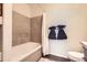 Neat bathroom featuring a bathtub, tiled walls, and towel racks, designed for a calming and refreshing experience at 5255 Memphis St # 311, Denver, CO 80239