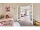 Bedroom with a view into the living room with modern neutral decor and a white couch at 5255 Memphis St # 311, Denver, CO 80239
