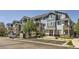 Low angle of blue, grey, and stone apartment building with assigned parking spaces on a clear day at 5255 Memphis St # 311, Denver, CO 80239
