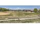 Scenic view of a green field with mountains in the distance, a walking path, and recreation space at 5255 Memphis St # 311, Denver, CO 80239