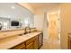 Modern kitchen with wooden cabinets, stainless steel appliances, and an open layout to the living area at 5255 Memphis St # 311, Denver, CO 80239