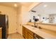 Well-lit kitchen with wood cabinets, stainless steel appliances, and an open view into the adjacent living area at 5255 Memphis St # 311, Denver, CO 80239