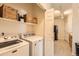 Functional laundry room equipped with modern washer and dryer units and ample storage at 5255 Memphis St # 311, Denver, CO 80239
