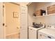 Well-organized laundry room features modern appliances, built-in shelving, and efficient layout at 5255 Memphis St # 311, Denver, CO 80239