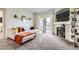 Living room with fireplace and sliding glass door to deck on a bright sunny day at 5255 Memphis St # 311, Denver, CO 80239