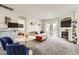 Spacious living room features a modern sofa, stylish fireplace, and a dining area with blue chairs at 5255 Memphis St # 311, Denver, CO 80239