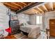 Partially finished basement bedroom with exposed beams and cozy atmosphere at 1075 Spartan Ave, Berthoud, CO 80513