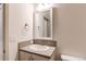 Neutral bathroom featuring a single vanity and large mirror at 1075 Spartan Ave, Berthoud, CO 80513