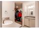Bright bathroom featuring a vanity, sink, and walk-in closet at 1075 Spartan Ave, Berthoud, CO 80513