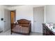 Charming Bedroom with a wood crib and grey trim, ready for a new Gathering at 1075 Spartan Ave, Berthoud, CO 80513