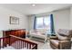 Bright Bedroom featuring a crib, a dresser and a chair at 1075 Spartan Ave, Berthoud, CO 80513