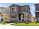 Charming two-story home with gray siding, stone accents, and a well-manicured lawn at 1075 Spartan Ave, Berthoud, CO 80513