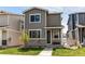 Charming two-story home with gray siding, stone accents, and a well-manicured lawn at 1075 Spartan Ave, Berthoud, CO 80513