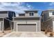 Attached two-car garage with gray door offers convenient parking and storage at 1075 Spartan Ave, Berthoud, CO 80513