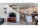 Open-concept kitchen with stainless steel appliances, a central island, and seamless access to the living room at 1075 Spartan Ave, Berthoud, CO 80513