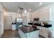 Modern kitchen with stainless steel appliances, a large island, and bright lighting at 1075 Spartan Ave, Berthoud, CO 80513