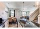 Modern kitchen with stainless steel appliances, a breakfast bar, and an open floor plan at 1075 Spartan Ave, Berthoud, CO 80513
