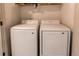 Efficient laundry room with modern side-by-side white washer and dryer units at 1075 Spartan Ave, Berthoud, CO 80513