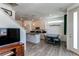 Cozy living room featuring wood floors, a dining area, and access to the kitchen at 1075 Spartan Ave, Berthoud, CO 80513