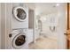 Compact bathroom with a stacked washer and dryer, a vanity and a toilet with tiled flooring at 31819 Rocky Village Dr # 208, Evergreen, CO 80439